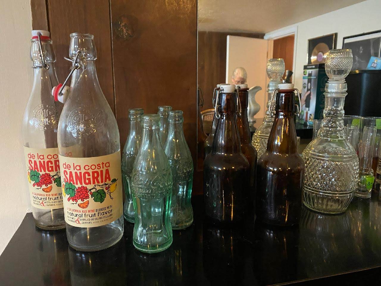 Different types of glass bottles on top of a kitchen counter