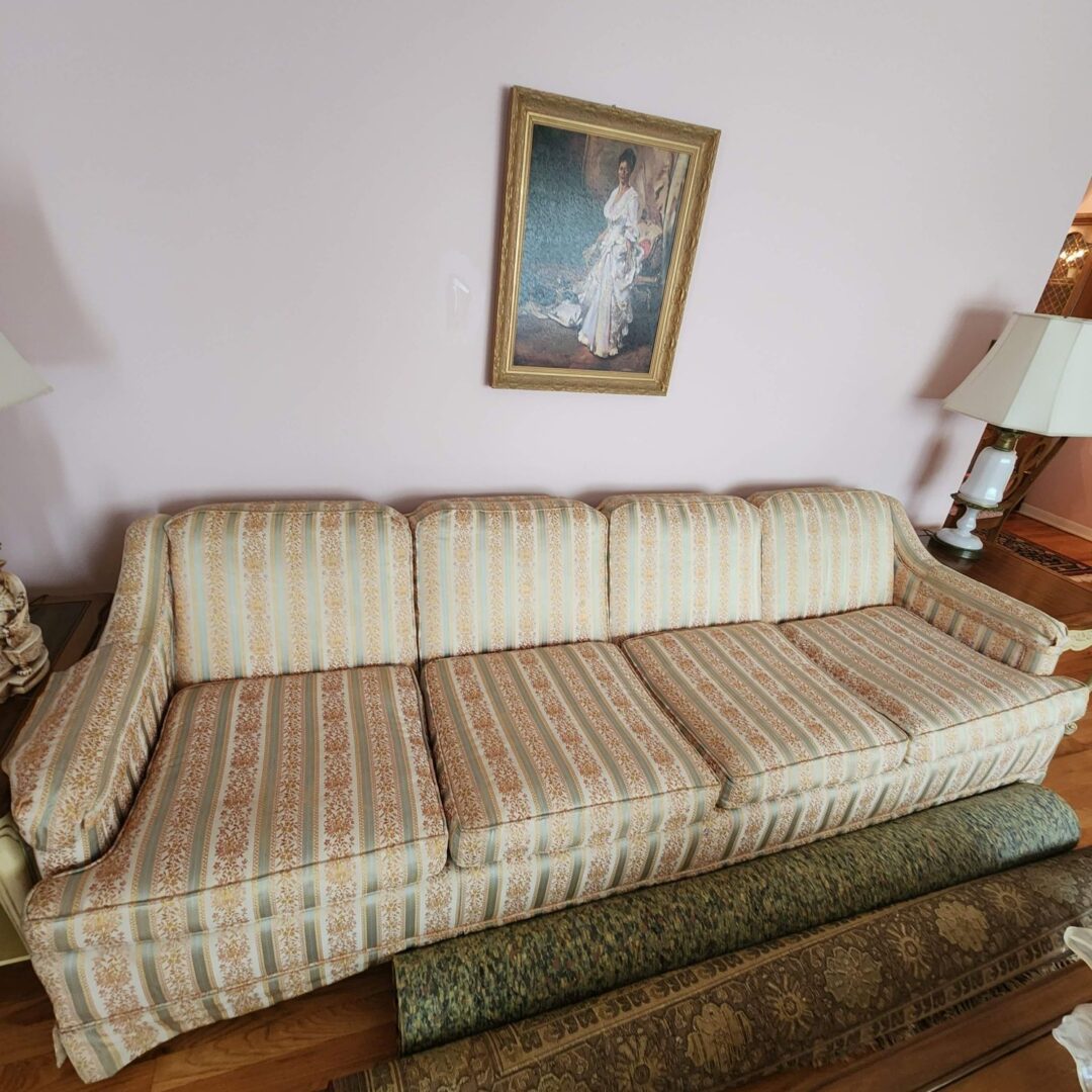 A Long White Color Couch With Design