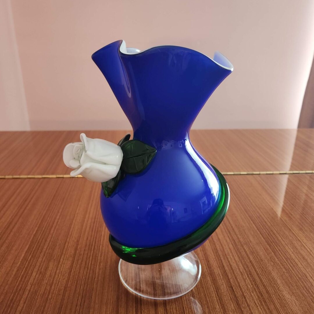 A Blue Color Glass Vase With a White Rose