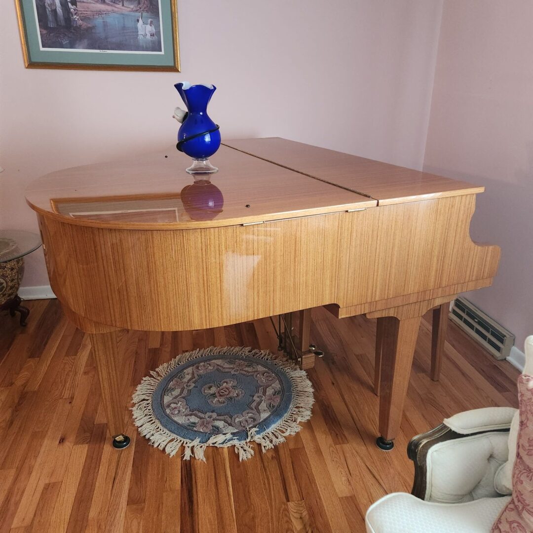 A Glass Vase on a Wooden Piano