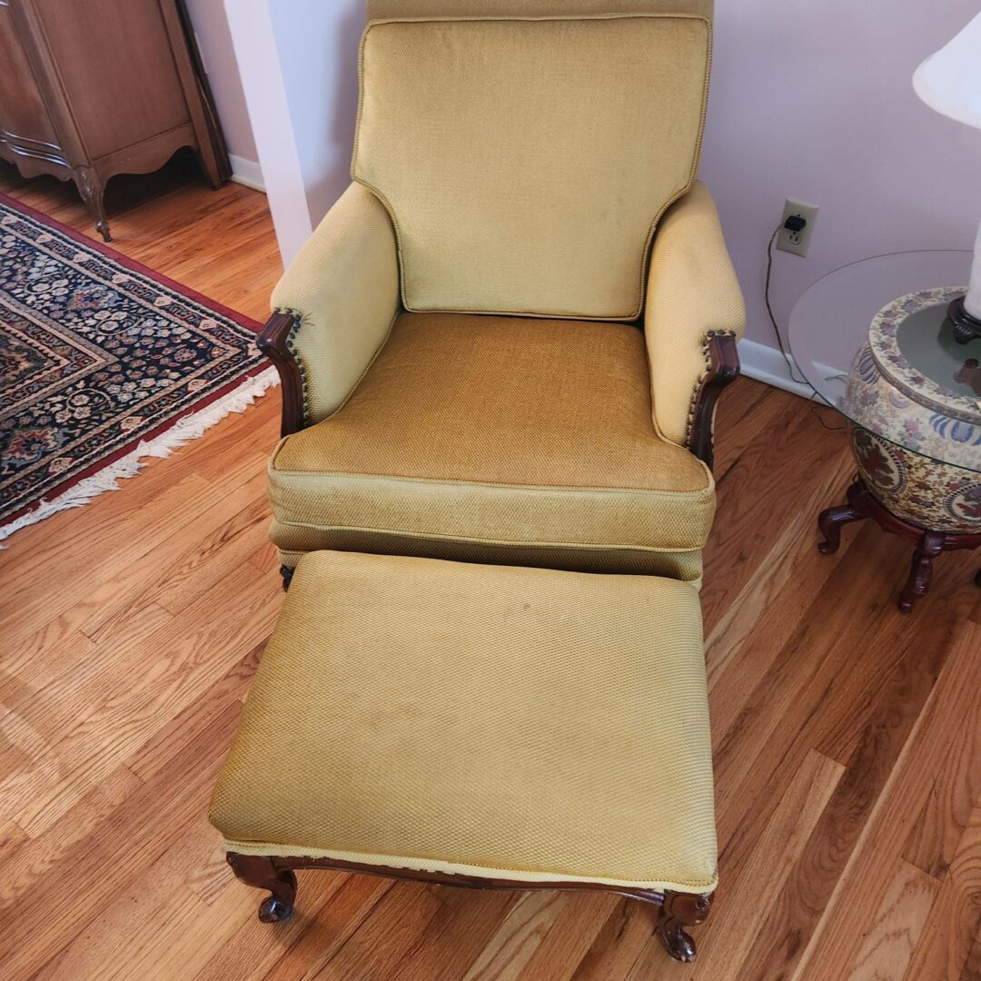 A Cream Color Couch With a Recliner Seat