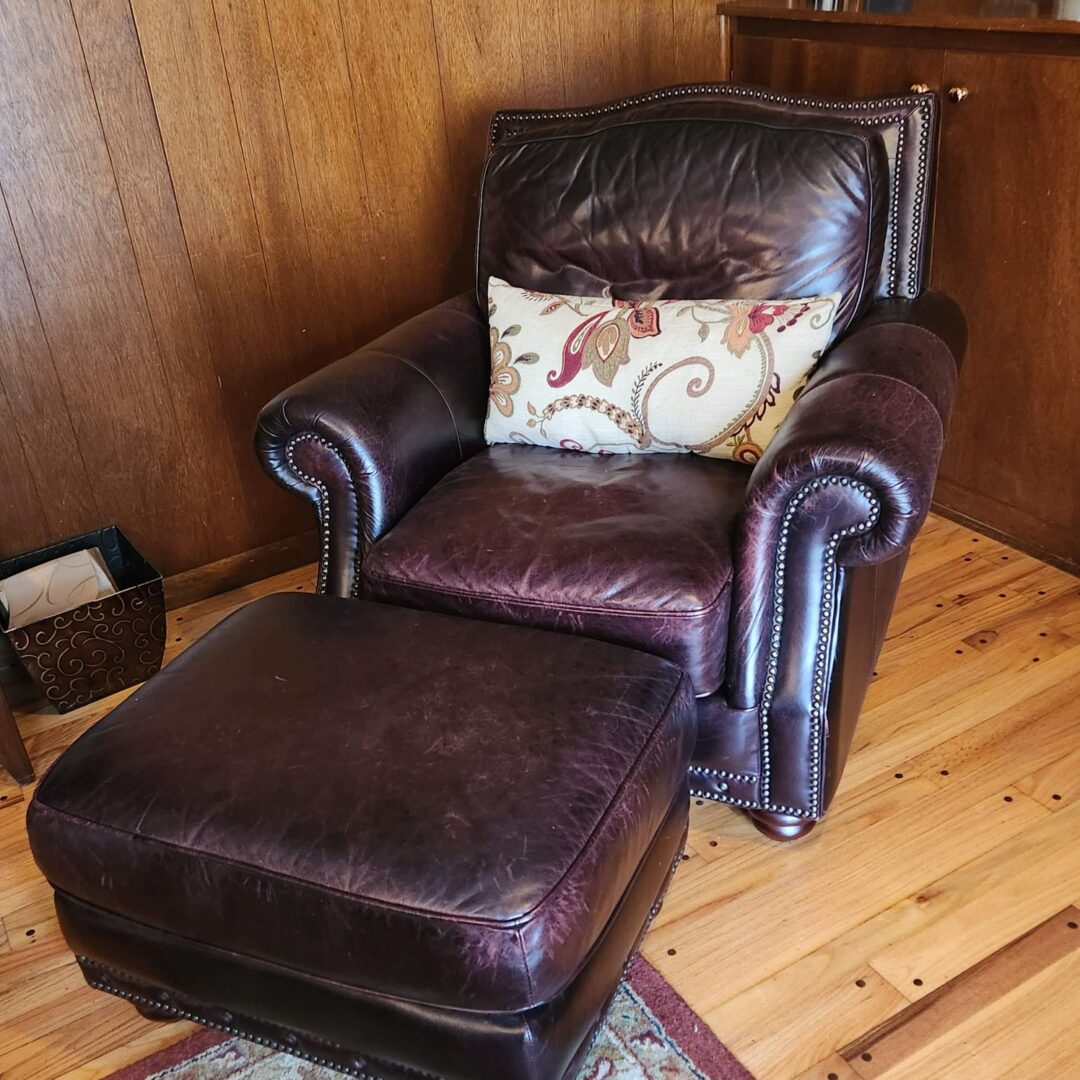 A Brown Color Arm Chair With a Leg Rest