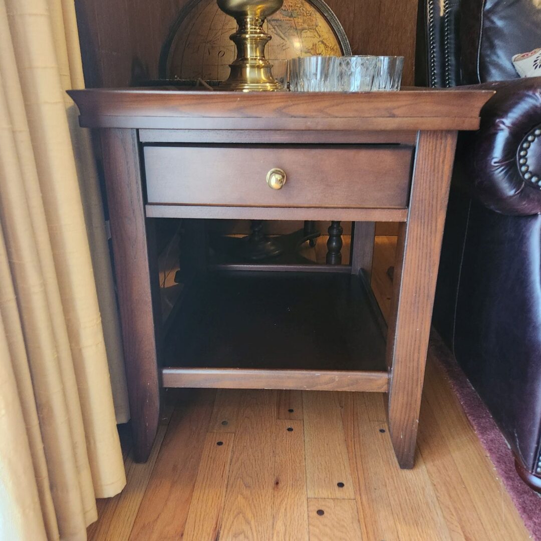 A Wooden Table Beside a Couch With a Drawer