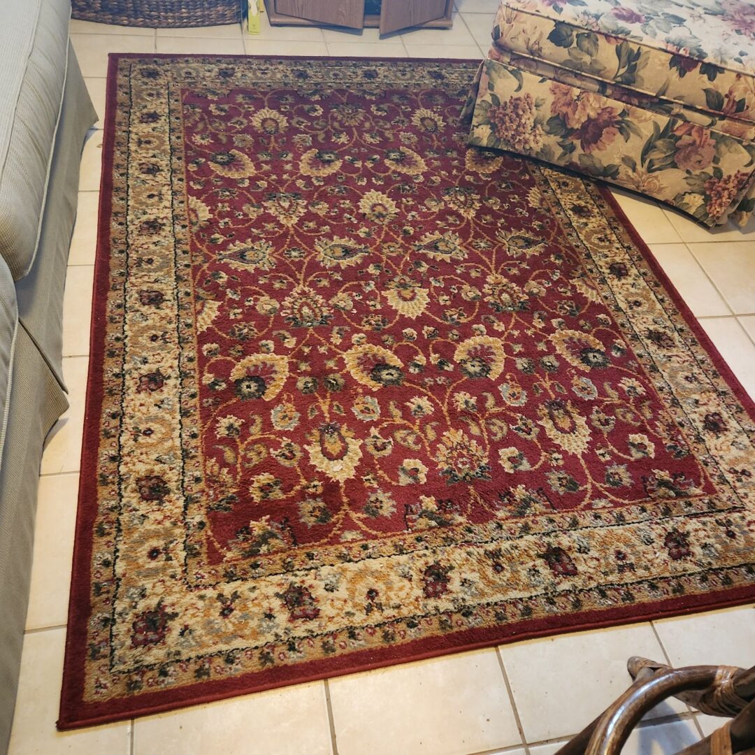 A Red and Cream Color Persian Rug Laid on the Floor