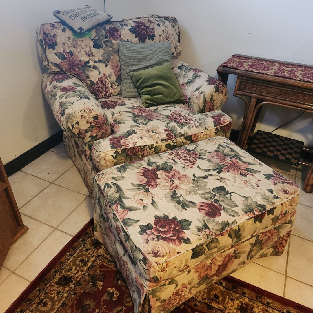 A Couch With a Leg Stand in Floral Pattern