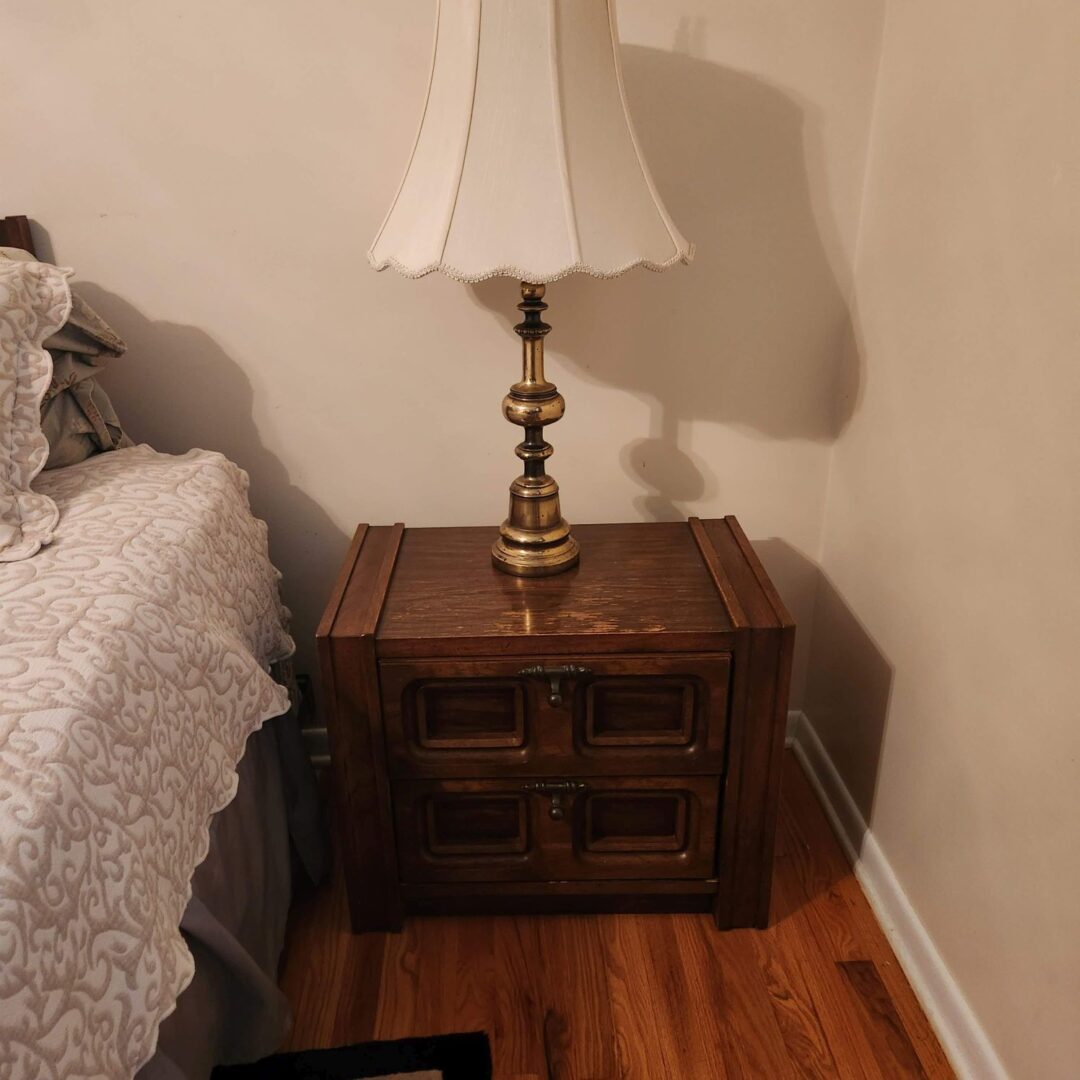 A White Color Lamp Placed on a Bed Side Table