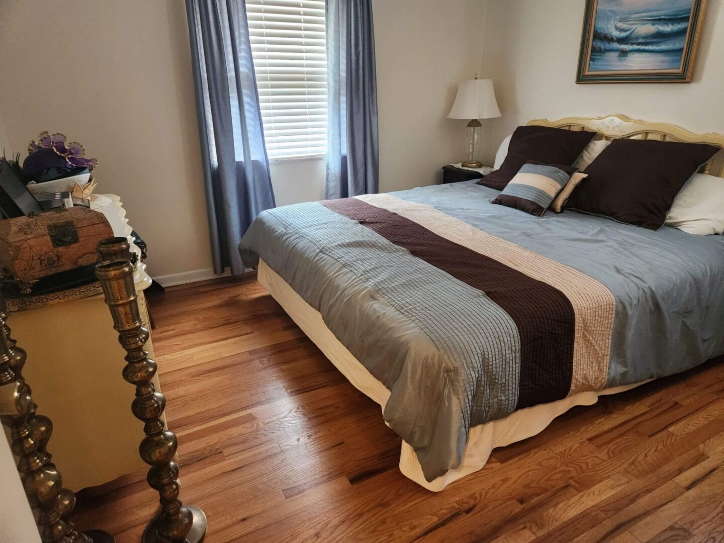 A bedroom with hardwood floors and a bed